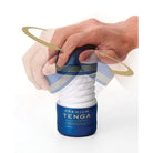 A person placing a TENGA Premium Rolling Head Cup - Disposable Masturbation Sleeve with care