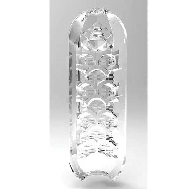 Clear glass vase with design bottom, next to TENGA Spinner 03 SHELL rotating reusable sleeve