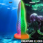 Glow-in-the-dark tentacle-shaped dildo with suction cup base for secure play