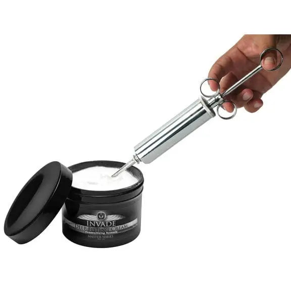 Stainless steel injector syringe extracting cream from black jar - The Grease Gun Stainless Steel Lube Launcher