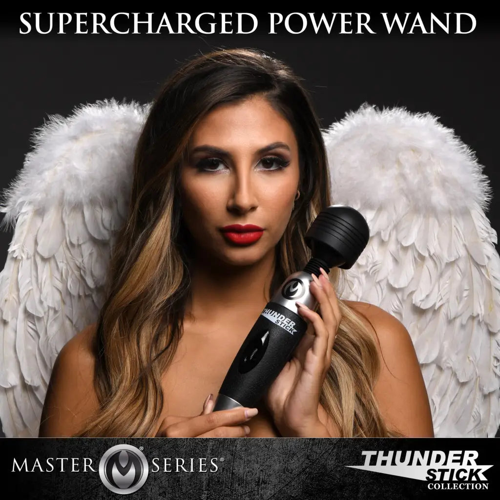 A woman with angel wings holding a Thunderstick 2.0 super charged power wand