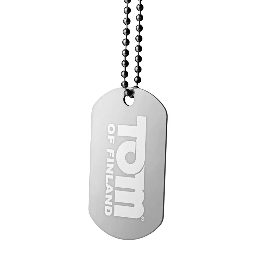 Dog tag with ’I love you’ on ’Tom Of Finland Hybrid Lube-8 Oz’ bottle