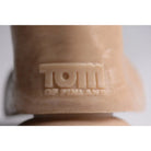 Embossed Tom of Finland logo on beige surface of Ready Steady Realistic Dildo packaging