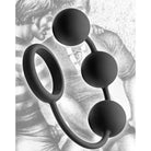 Tom of Finland silicone cock ring with weighted balls against a blurred backdrop