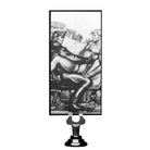 Erotic artwork on decorative stand with Tom Of Finland Silicone Vibrating Anal Plug