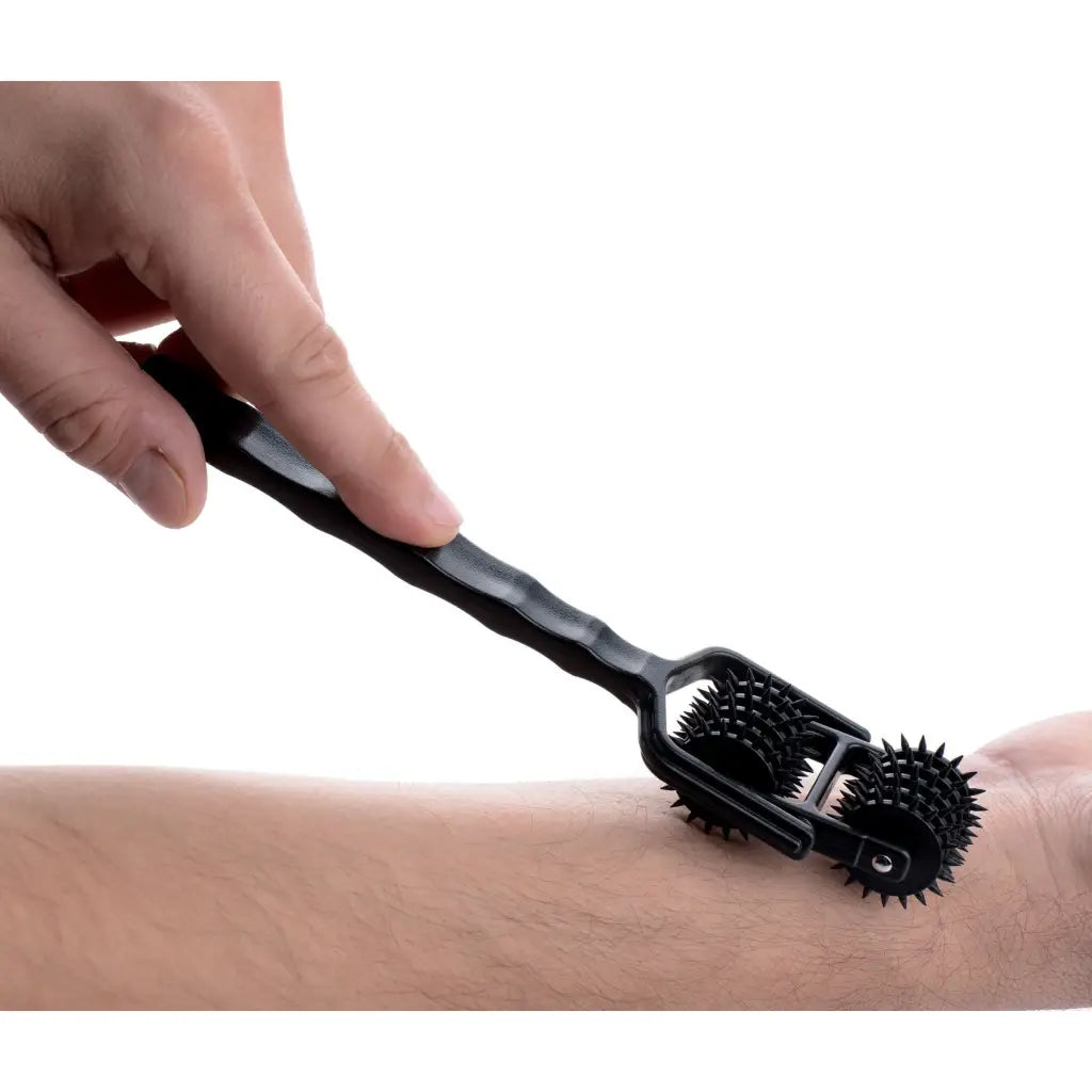 Using Transfix 10 Reel Dual Pinwheel on skin for soothing massage with spiked wheels