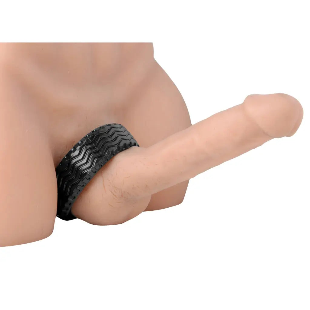 A 3D image of a man’s hand holding the Tread Ultimate Tire Cock Ring