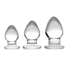 Triplets 3 Piece Glass Anal Plug Kit: Three glass candles on a white background