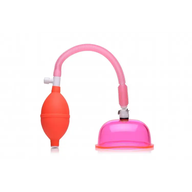 Vaginal pump with pink suction cup and red squeeze bulb connected by flexible tubing