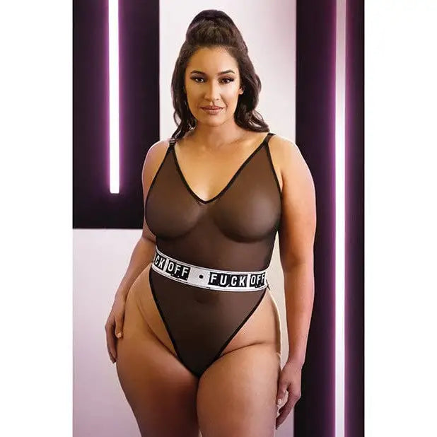 Woman in Vibes Fuck Off Mesh Playsuit, revealing brown bodysuit with provocative text waistband