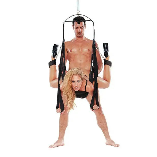 Man and woman in a black bikini and harness on a bondage pleasure swing