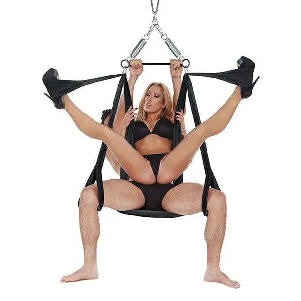 A woman in a black bikini using the Whip Smart Yoga Pleasure Swing for aerial exercises