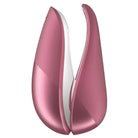 Pair of pink and white plastic vases with Womanizer LIBERTY Air Clitoral Stimulator in view