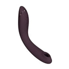 Curved dark purple Womanizer OG Long pleasure air massager with buttons and textured tip