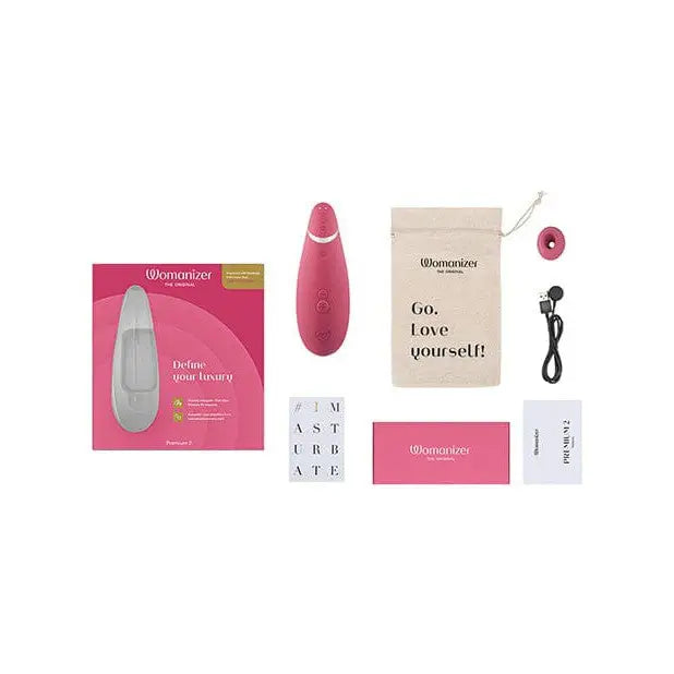 Womanizer PREMIUM 2 with pink device, bag, and cord showcasing Pleasure Air Technology