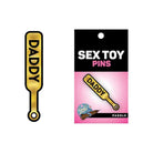 Gold daddy paddle pin with ’DADDY’ text, a unique and playful sex toy accessory