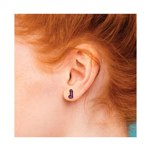 Purple eggplant-shaped earring in ear lobe - Wood Rocket sex toy jewelry