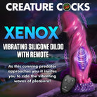 Pink alien-like vibrating silicone dildo with remote, suction cup base, and curved shaft