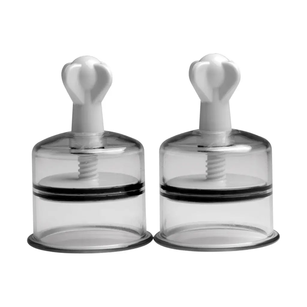 Two clear glass salt shakers with black lids from Xl Nipple Suckers collection